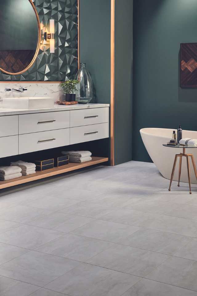 stone look luxury vinyl tile in modern bathroom with bold green walls and textured backsplash